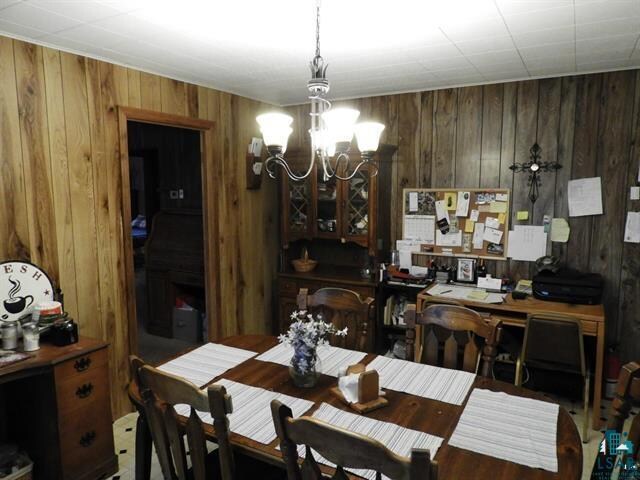 19020 US Highway 2, Mason, WI 54856 - dining room with wooden walls and a notable chandelier