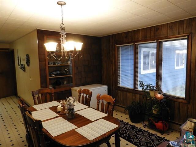 19020 US Highway 2, Mason, WI 54856 - dining space featuring an inviting chandelier and wood walls