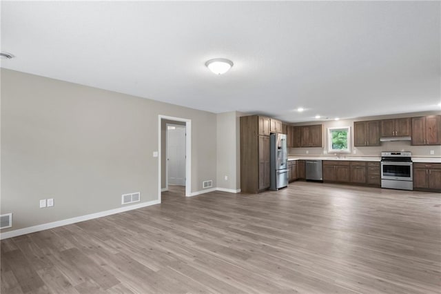 kitchen with stainless steel appliances and light hardwood / wood-style floors