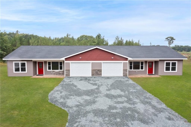 ranch-style home with a garage and a front lawn