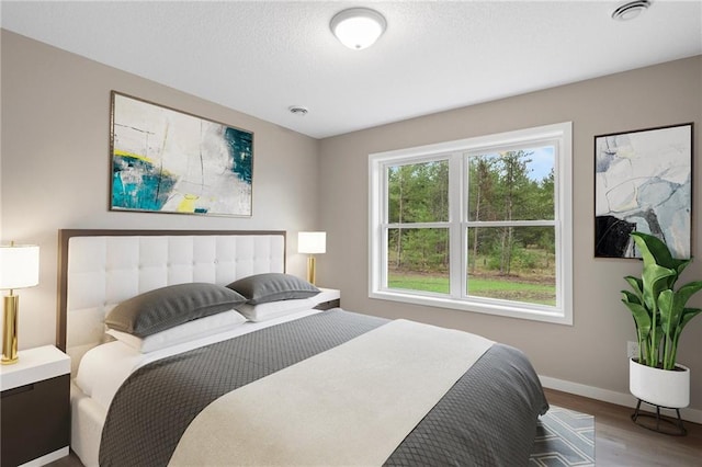 bedroom with hardwood / wood-style floors