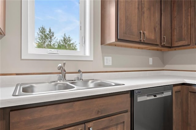 kitchen with stainless steel dishwasher, sink, and dark brown cabinets