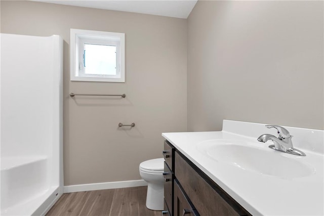 bathroom featuring hardwood / wood-style floors, vanity, and toilet