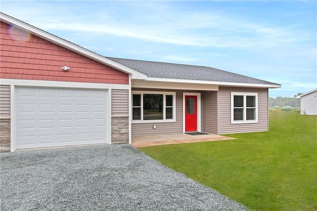 ranch-style house with a garage and a front lawn