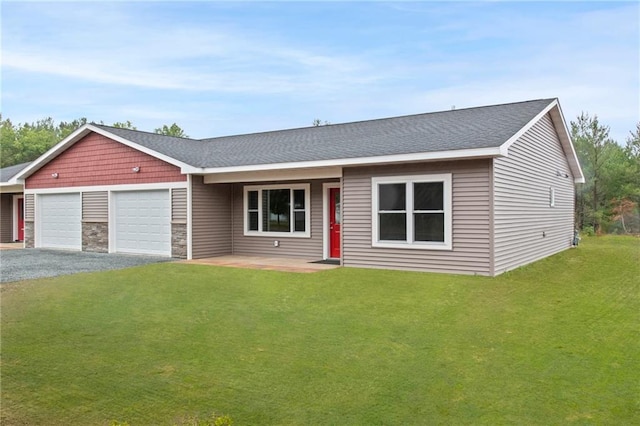 single story home featuring a garage and a front lawn