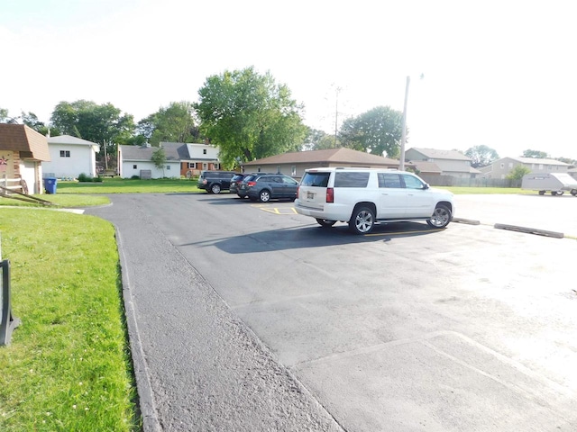 view of vehicle parking featuring a yard