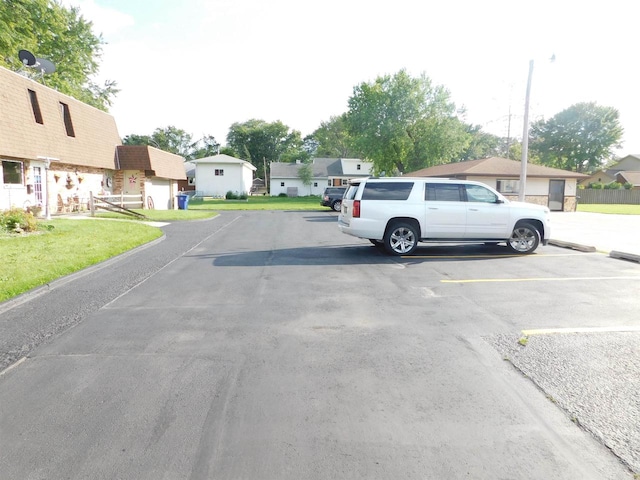 view of car parking with a lawn