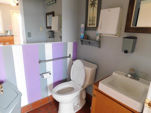 bathroom with toilet, tile floors, and large vanity