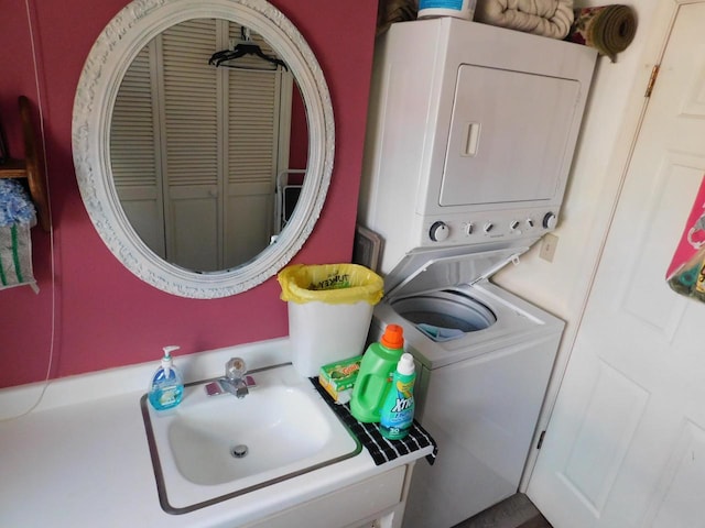 bathroom with stacked washer and dryer and sink