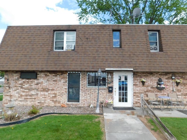 view of front of house with a front yard and a patio area