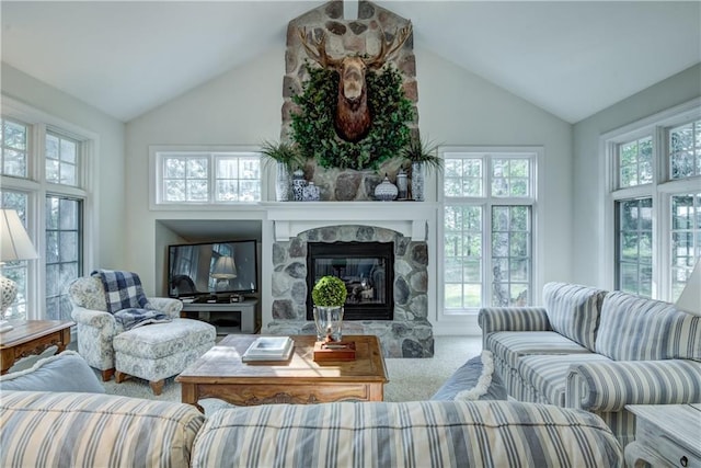 sunroom with a fireplace, a healthy amount of sunlight, and lofted ceiling