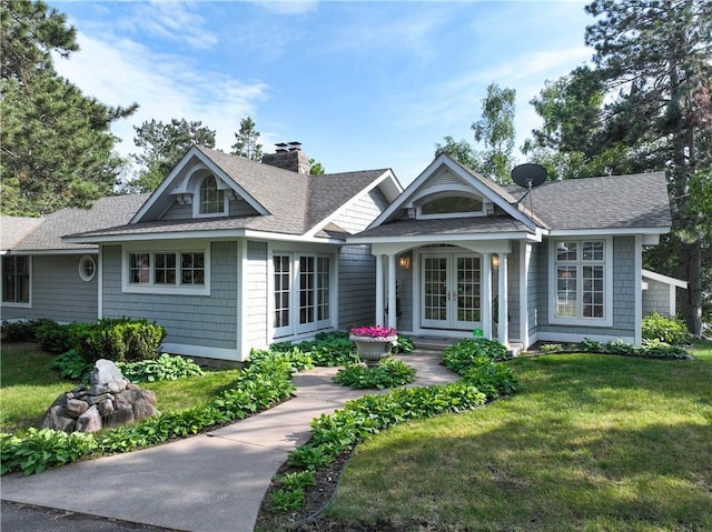 view of front of house featuring a front yard and french doors