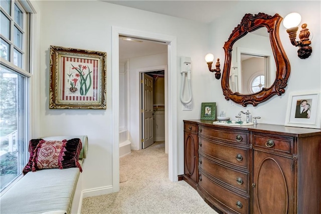 interior space featuring a wealth of natural light and light colored carpet