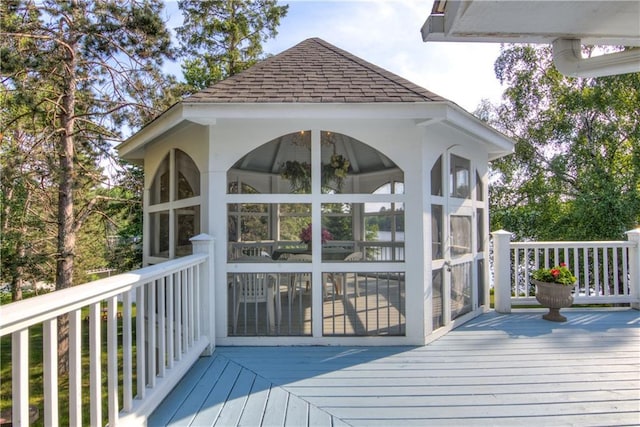 wooden deck featuring a sunroom