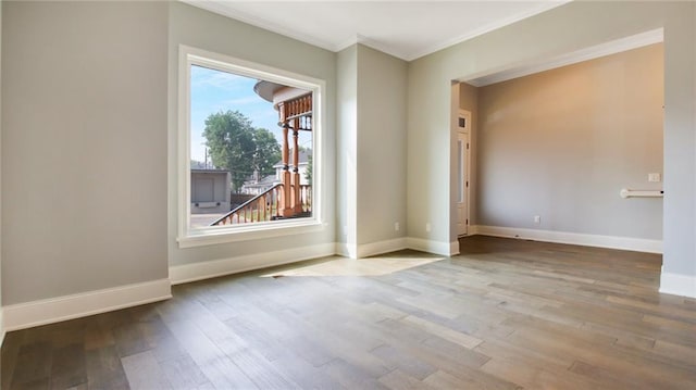 spare room with plenty of natural light, ornamental molding, and hardwood / wood-style flooring