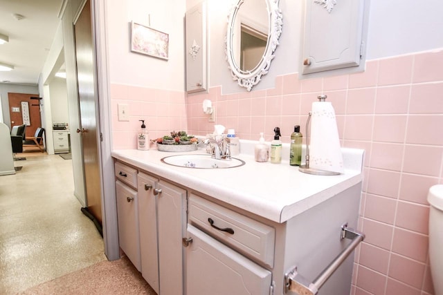 bathroom featuring tile walls, backsplash, and vanity with extensive cabinet space