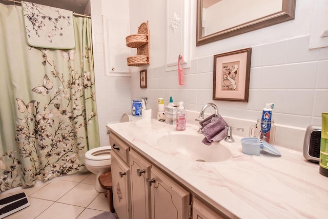 bathroom with tile flooring, oversized vanity, toilet, and tile walls