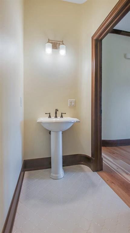 bathroom with hardwood / wood-style floors