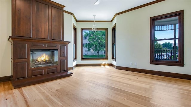 interior space featuring crown molding and light hardwood / wood-style floors