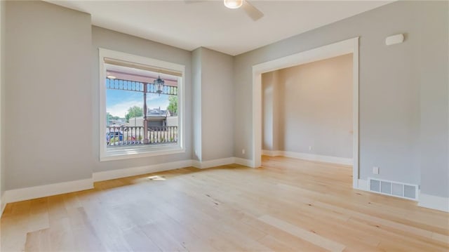 empty room featuring ceiling fan and light wood-type flooring