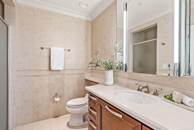 bathroom featuring tile walls, tile floors, toilet, vanity, and crown molding