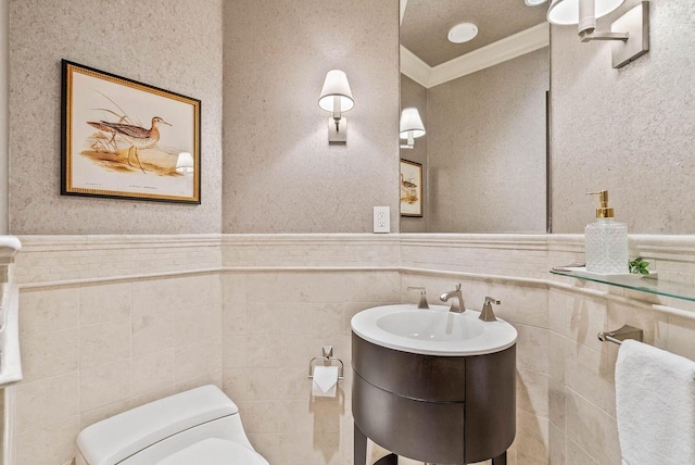 bathroom featuring a textured ceiling, tile walls, toilet, and ornamental molding