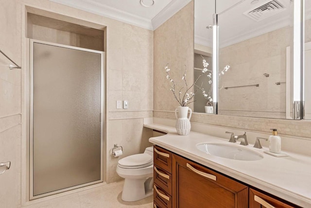 bathroom with toilet, a shower with door, vanity, crown molding, and tile walls