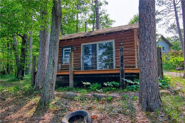 view of side of home with a wooden deck