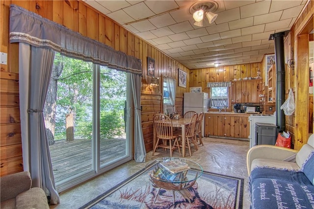 interior space featuring a wood stove and wood walls