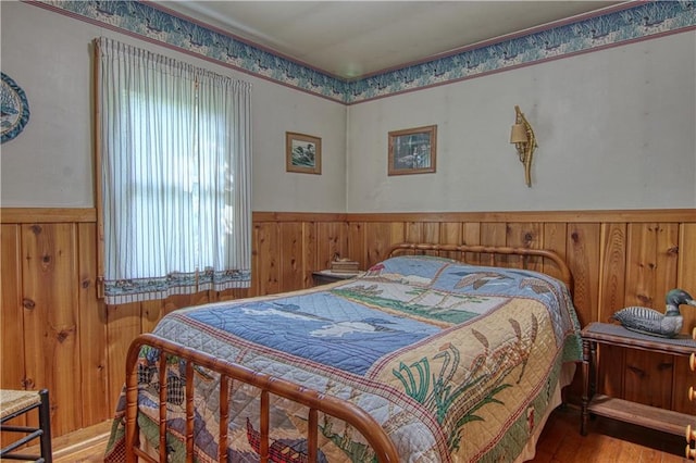 bedroom with multiple windows and light hardwood / wood-style floors