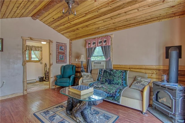 living room with vaulted ceiling with beams, a wood stove, a baseboard heating unit, wood ceiling, and dark hardwood / wood-style flooring