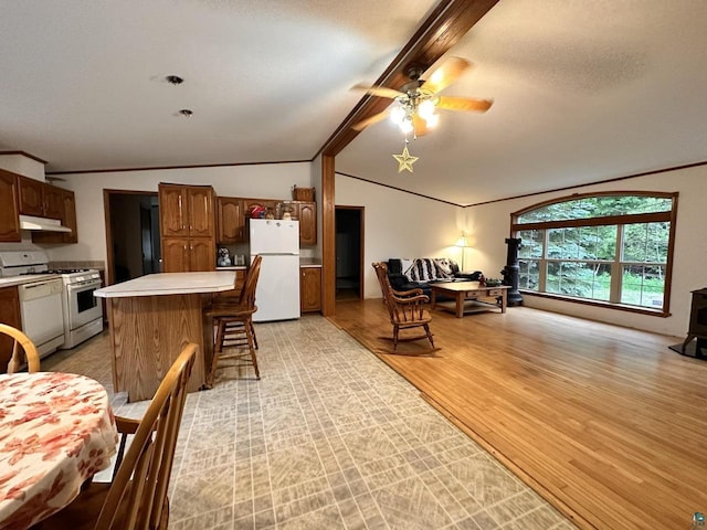 interior space with ceiling fan, vaulted ceiling with beams, light hardwood / wood-style flooring, and crown molding