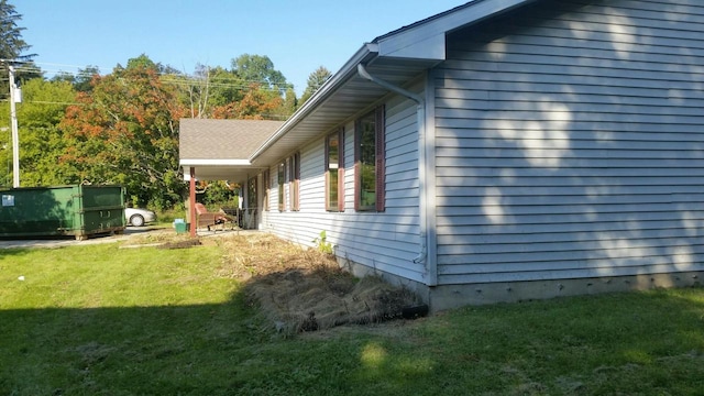 view of side of home featuring a yard