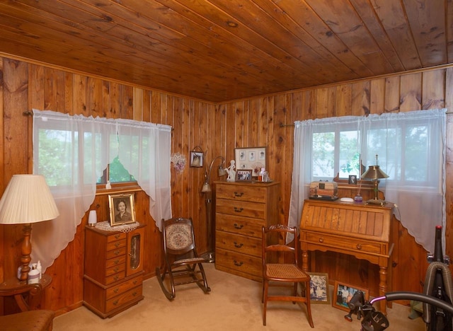 living area with light carpet, wood walls, and wooden ceiling