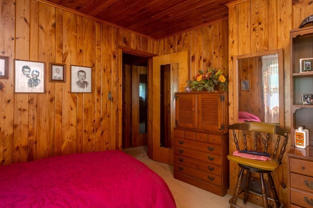 bedroom featuring light carpet and wood walls