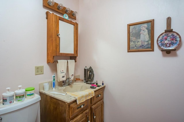 bathroom featuring toilet and vanity