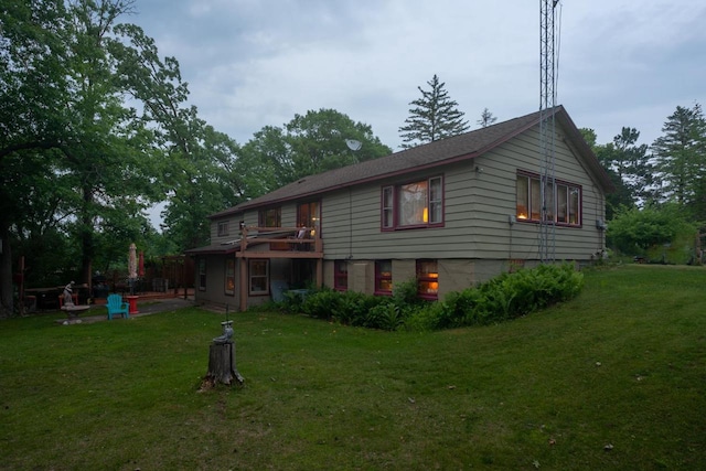 rear view of house featuring a lawn