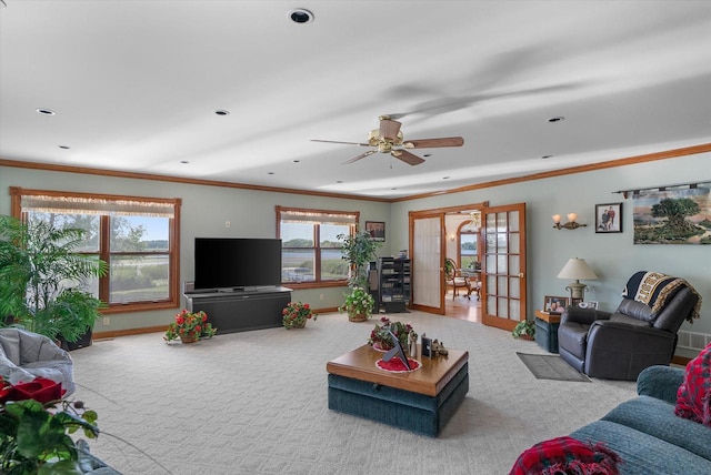 carpeted living room featuring plenty of natural light, french doors, ornamental molding, and ceiling fan