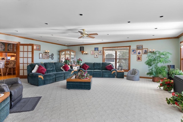 carpeted living room with ceiling fan and crown molding