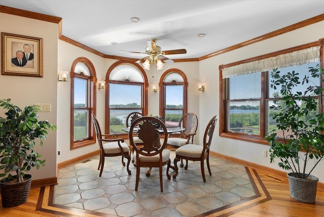 dining area featuring ceiling fan, crown molding, and light hardwood / wood-style floors