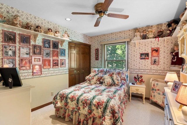 carpeted bedroom featuring a closet and ceiling fan