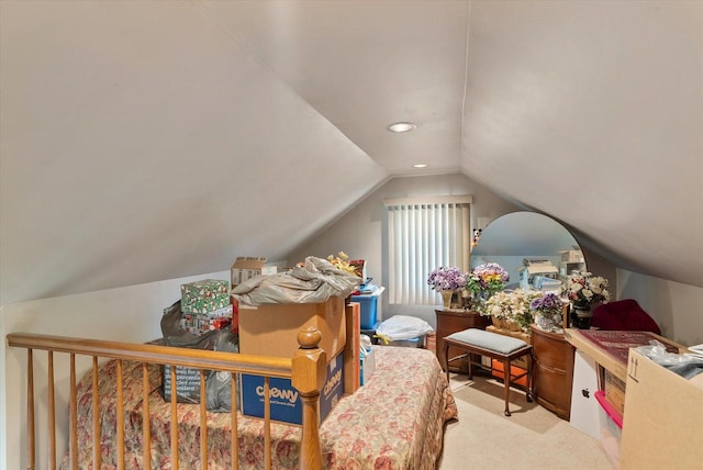 bedroom featuring lofted ceiling and light colored carpet