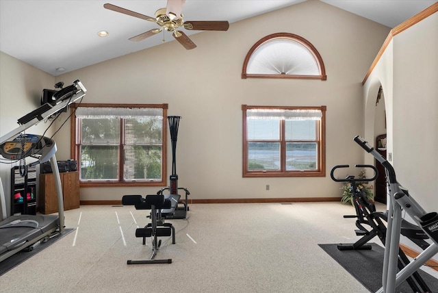 workout area with ceiling fan, lofted ceiling, light colored carpet, and plenty of natural light