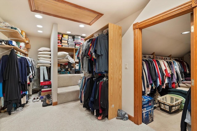 walk in closet featuring light carpet