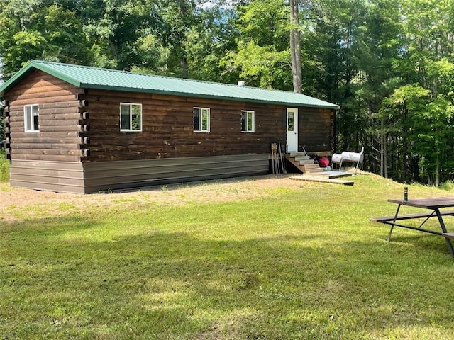 back of property featuring a yard