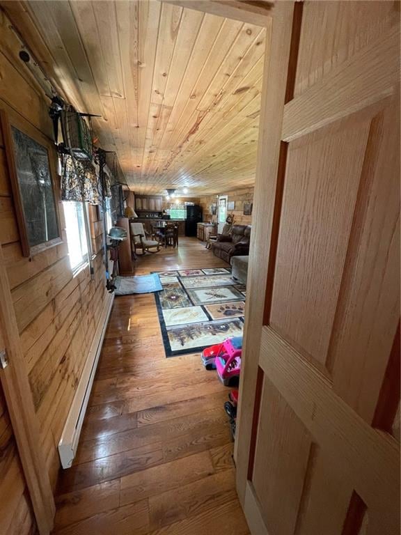 N2141 Pondell Ln, Bruce, WI 54819 - hall with wood ceiling, baseboard heating, hardwood / wood-style floors, and wood walls