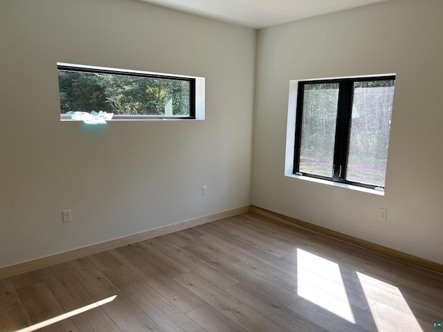 unfurnished room with hardwood / wood-style floors