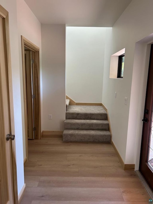 staircase featuring light wood-type flooring