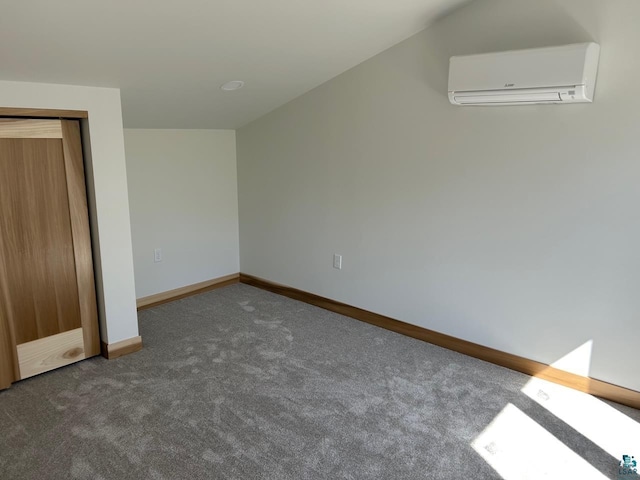 unfurnished bedroom with carpet floors, lofted ceiling, and a wall mounted AC