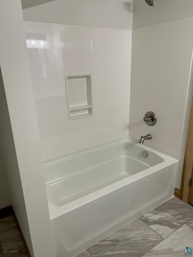 bathroom with tile floors and  shower combination